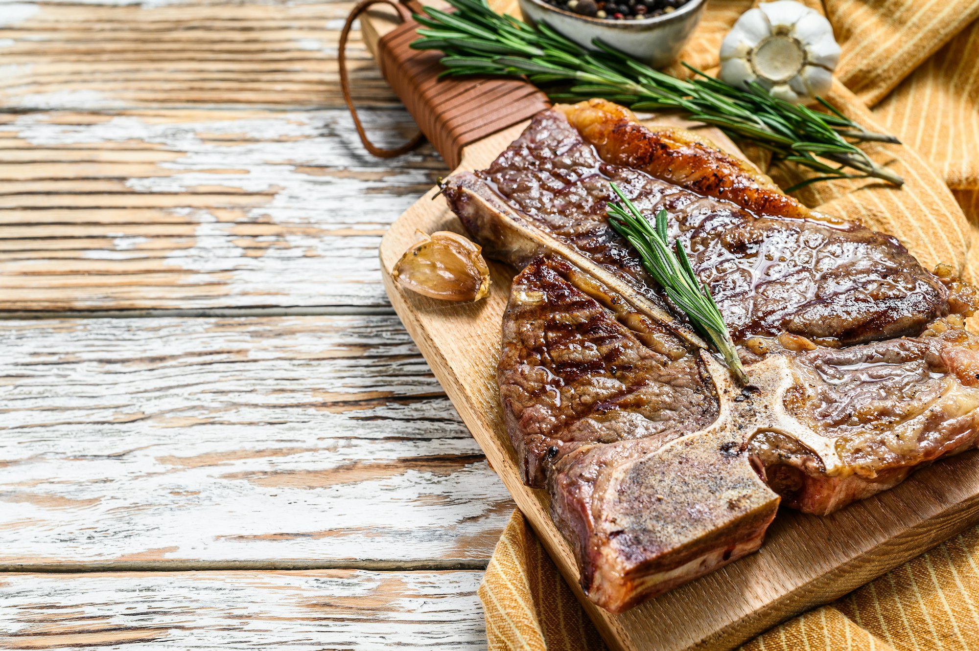 Grilled T bone steak on a chopping Board. Cooked tbone beef